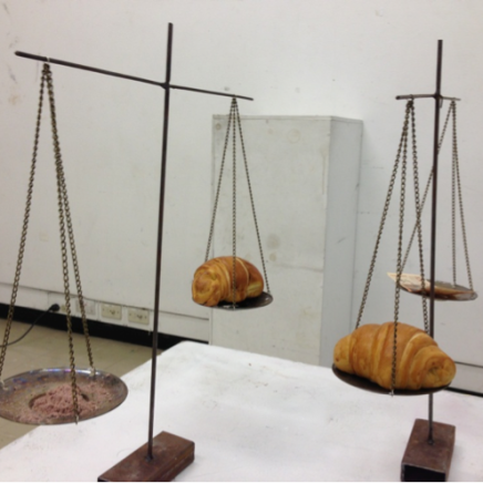 Intervened bill, Bread and the weighing scales made with metal. Powder of bills. Bread. 2012 Bogotá. Colombia